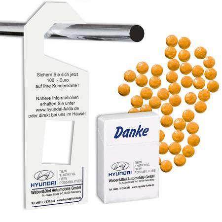 Serviceaufhänger mit herausnehmbarer Papp-Werbedose gefüllt mit ACE Vitamindragees